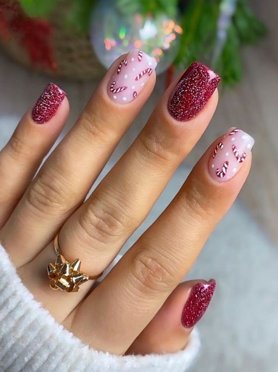 17. Festive Glitter Nails with Candy Cane Accents
