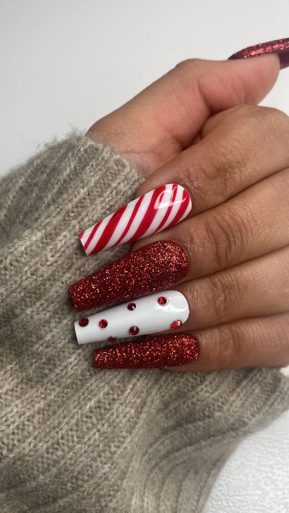 19. Festive Candy Cane and Glitter Holiday Nail Art
