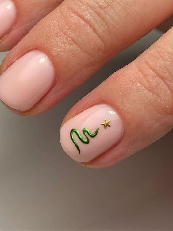 22. Minimalist Christmas Tree Nail Design with a Touch of Gold
